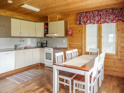 Interior view of Kaisla showing the high ceiling living room and kitchen.