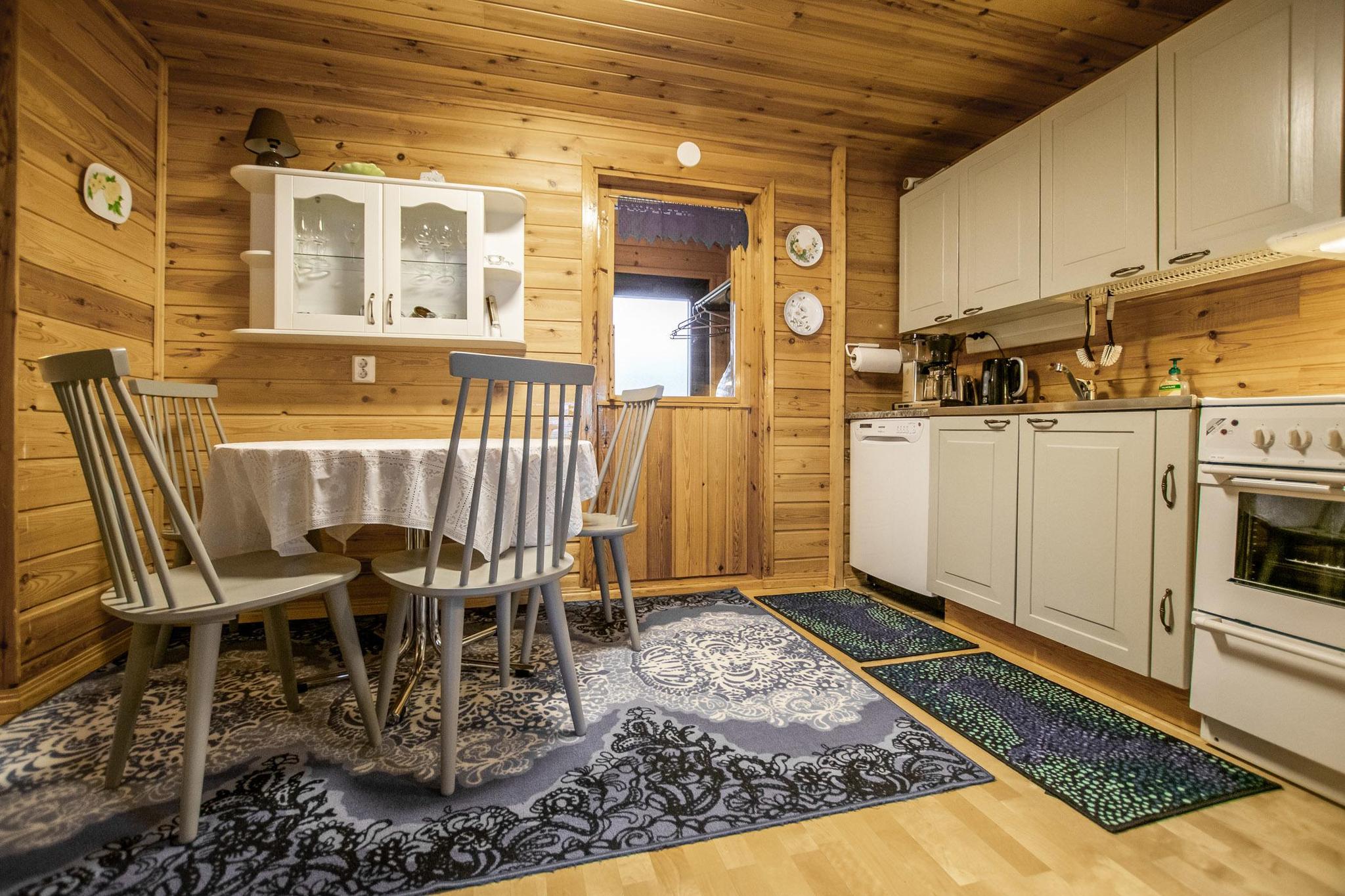 Inside view of Kaunotar's living room featuring a traditional soapstone fireplace.