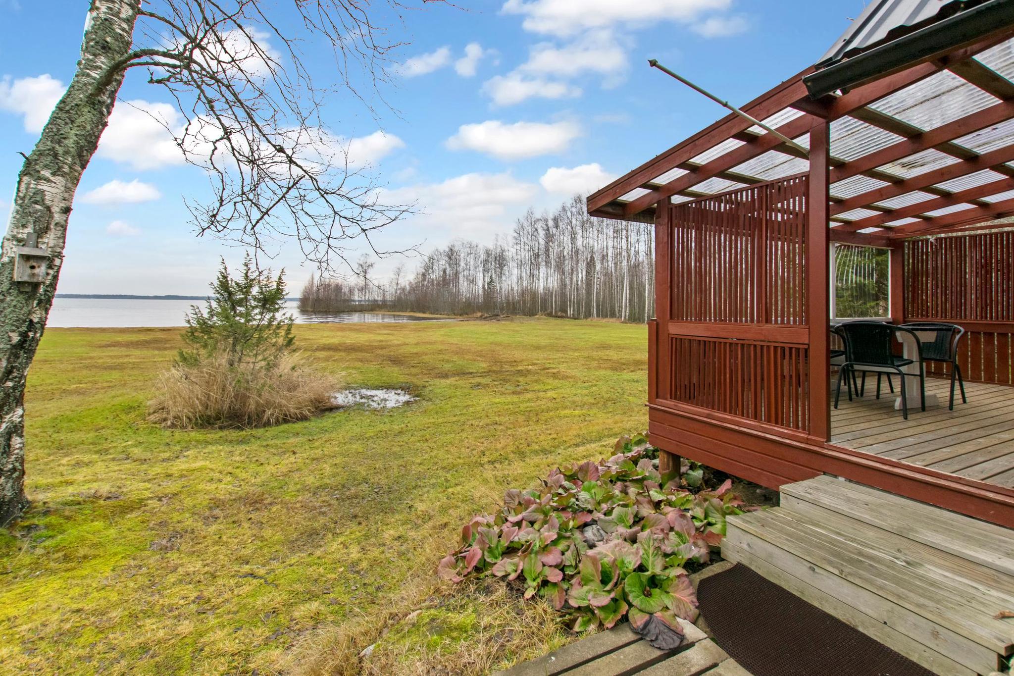 Spacious and partially glazed terrace of Missi, offering views of the surrounding natural landscape.