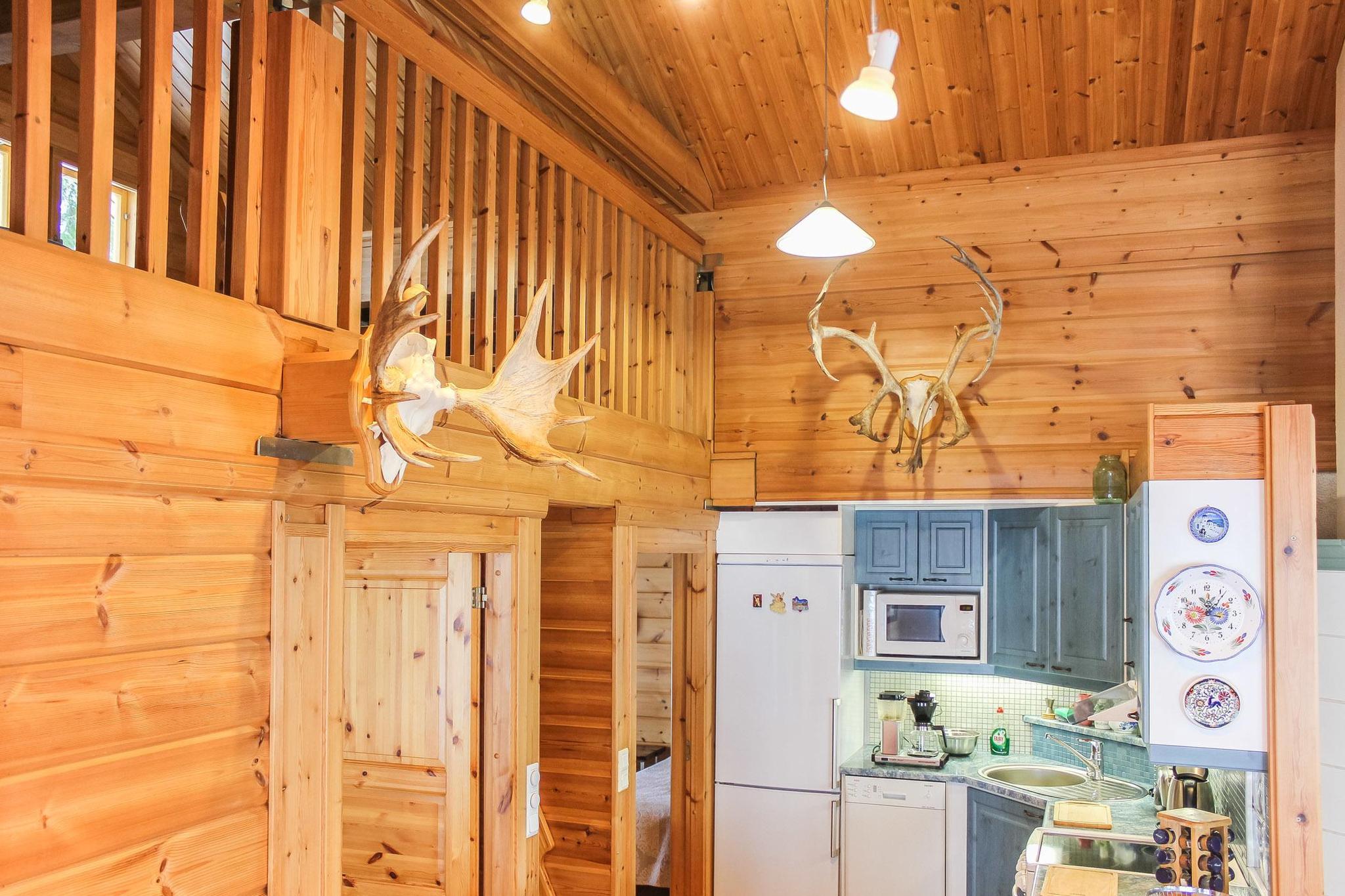 Cozy interior of Hamppulahti cottage with a wood-burning fireplace.