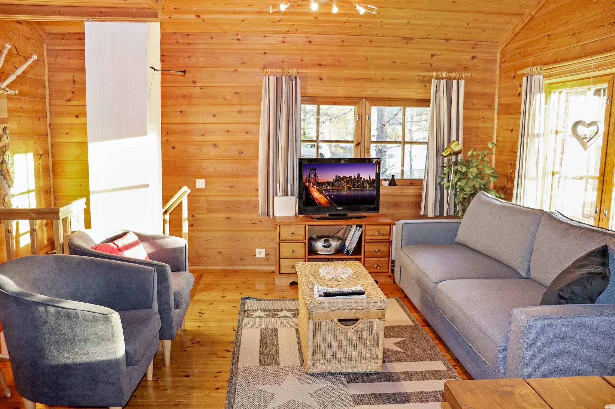 Cozy living room inside Hyrynhovi Cottage with a fireplace and comfortable seating.