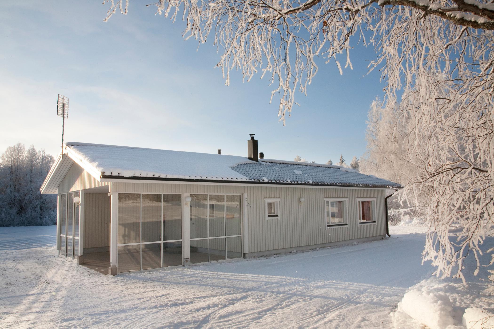 Front view of the Metsätähti cottage in a serene forest setting.