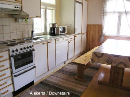 Spacious and cozy living area inside Vaaran Loma-Asunto, with a large fireplace.