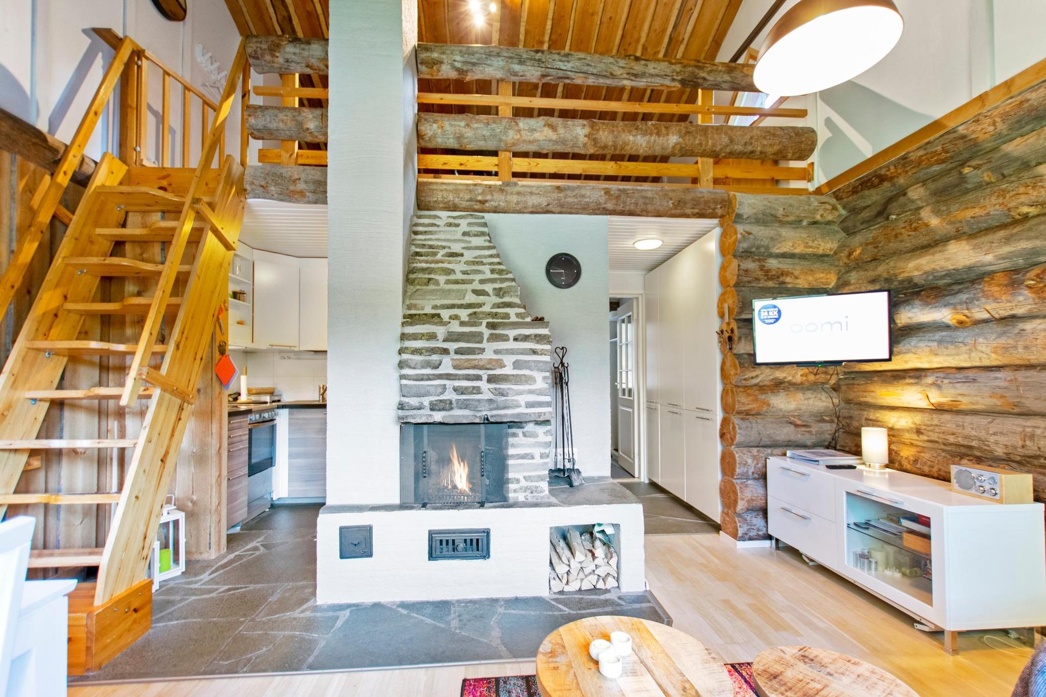 Warm and inviting living room with a natural stone fireplace.