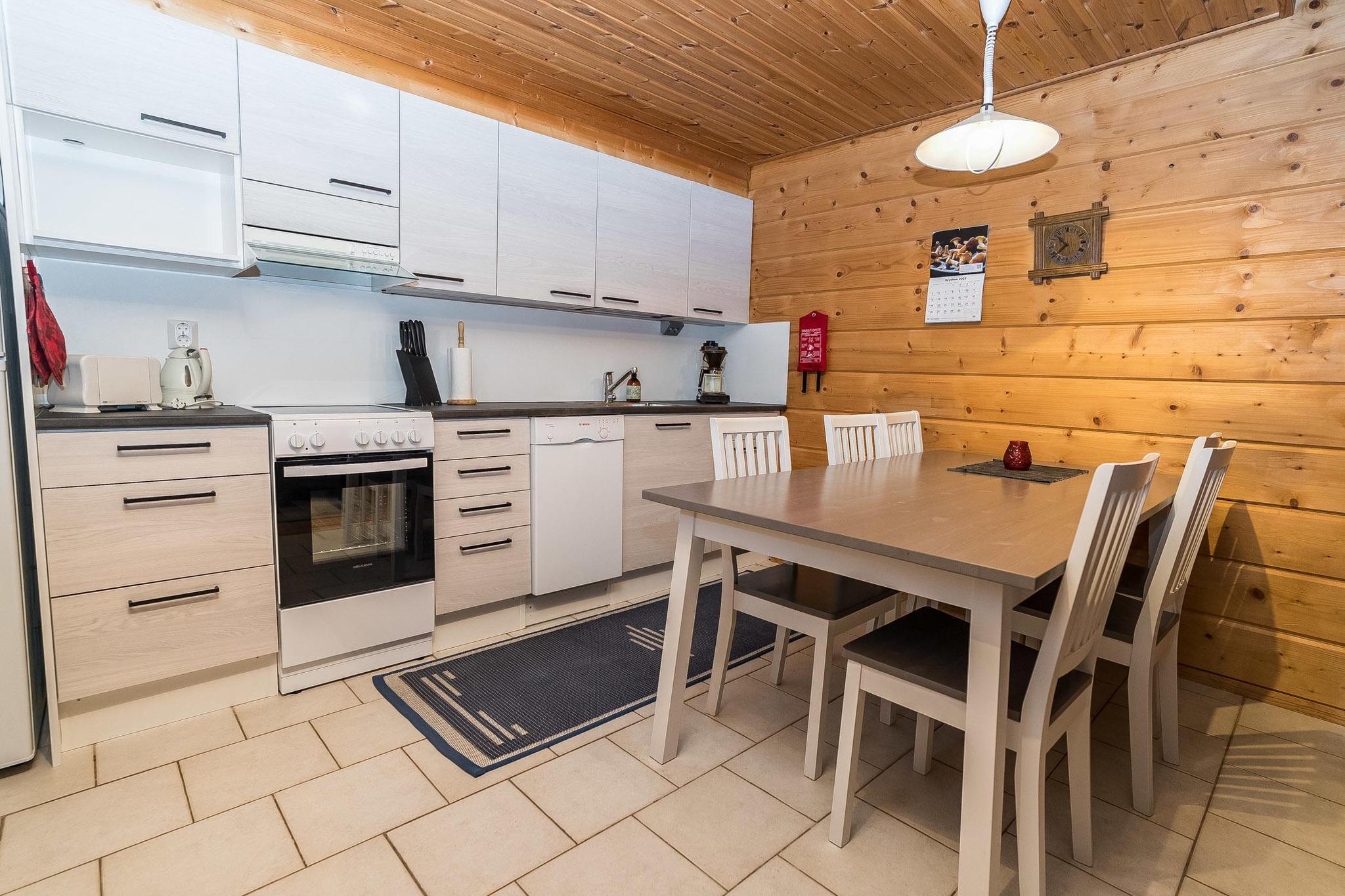 An apartment located in a log-built semi-detached house at Rukannaava 1A in Vuosselinrinne, Kuusamo, Northern Ostrobothnia, approximately 25km north of Kuusamo and 800m from Vuosseli (Eastern Ruka). Built in 2000, the apartment includes a bedroom with a double bed, a second bedroom on a loft with two beds, an additional loft space with a convertible sofa for two and two more beds, and a combined kitchen and living room. The total area is 52 m² with an additional 26 m² loft, with the loft's highest point at 190 cm.