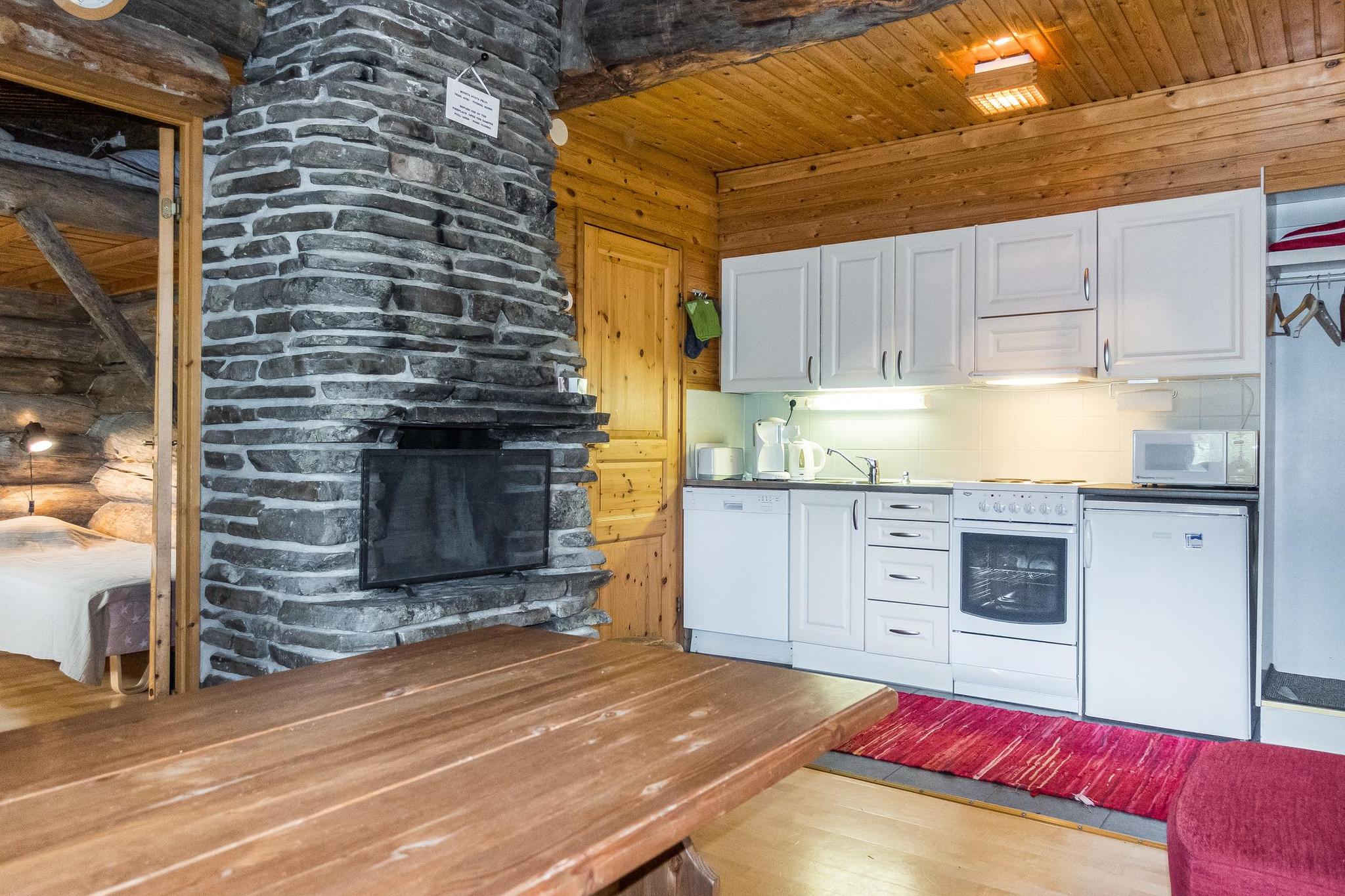 A kelo log-built semi-detached cabin located at the top of the Iso-Syöte fell, 140 km northeast of Oulu in a village of mountain lodges. Built in 1985, this apartment offers a living room/kitchen with a spreadable sofa, a bedroom with two beds and an additional loft bed accessible via a steep ladder. It includes a sauna, a washroom/WC, and a covered terrace, boasting beautiful views of the surrounding landscapes. Nearby amenities include ski slopes, ski trails, and restaurant services. Pets are welcome. The apartment can accommodate up to 5 guests, though it is recommended for 4 guests (2 adults and 1-2 children) for comfort.