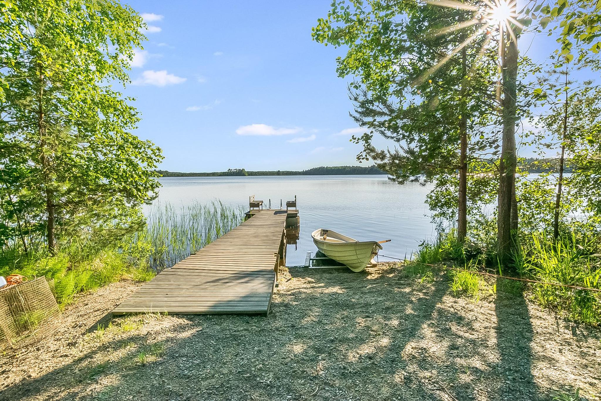 Summer view of the exterior of Laavusranta surrounded by lush greenery.