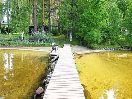 Exterior view of Simola's traditional Finnish architecture in a serene forest setting.